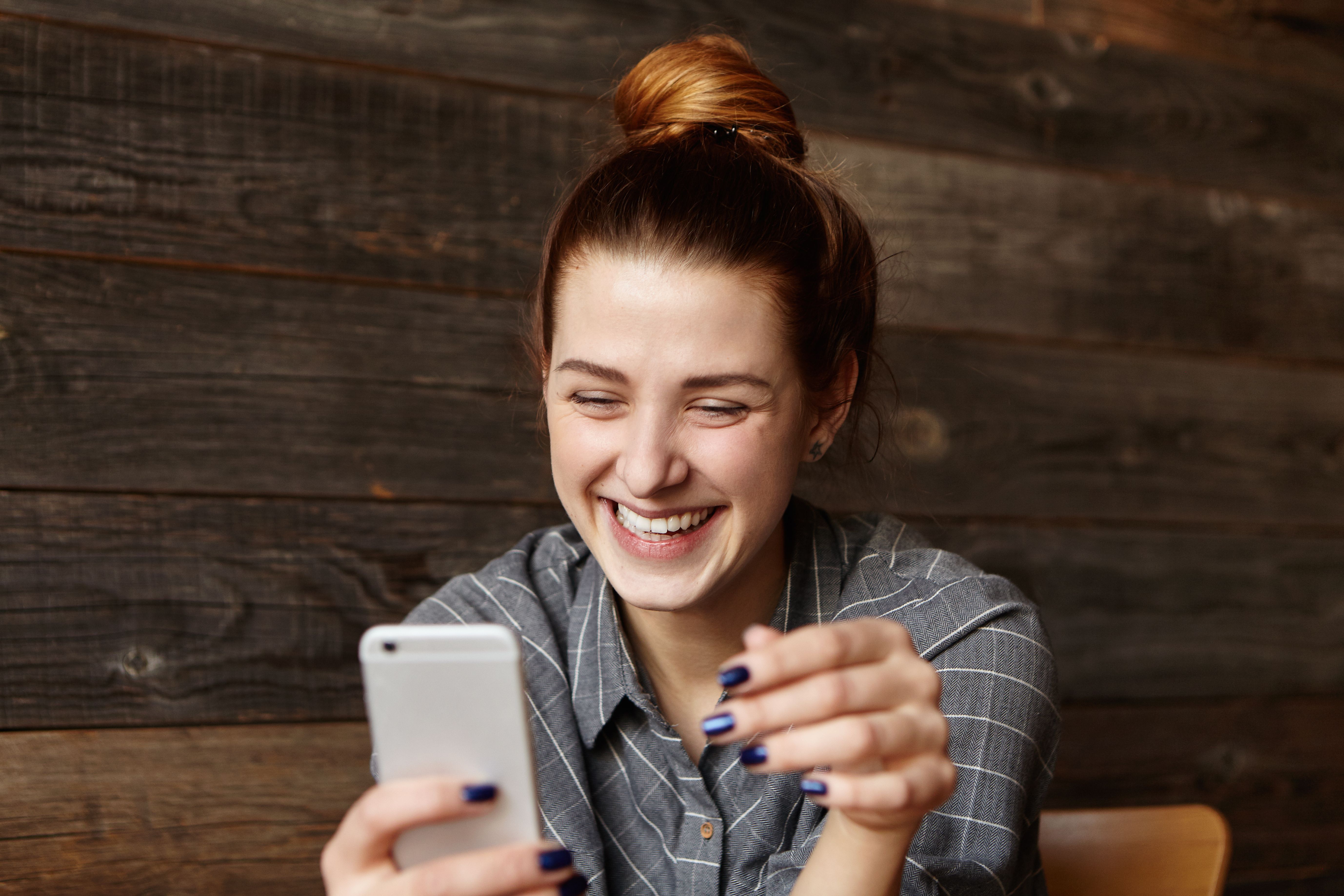 cheerful-young-redhead-female-student-with-cute-smile-siting-modern-cafe-interior.jpg