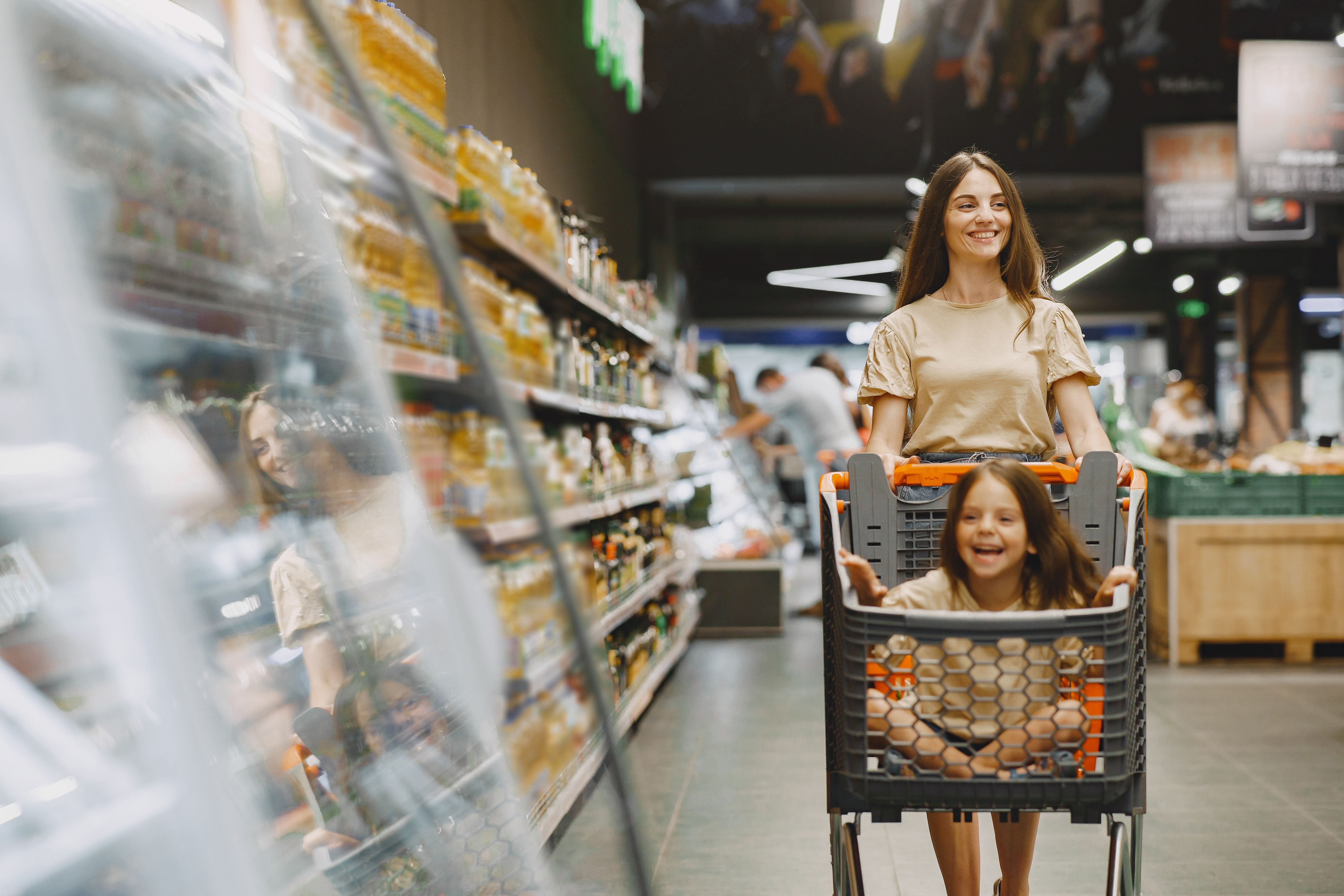 family-supermarket-woman-brown-t-shirt-people-choose-products-mother-with-daughter.jpg