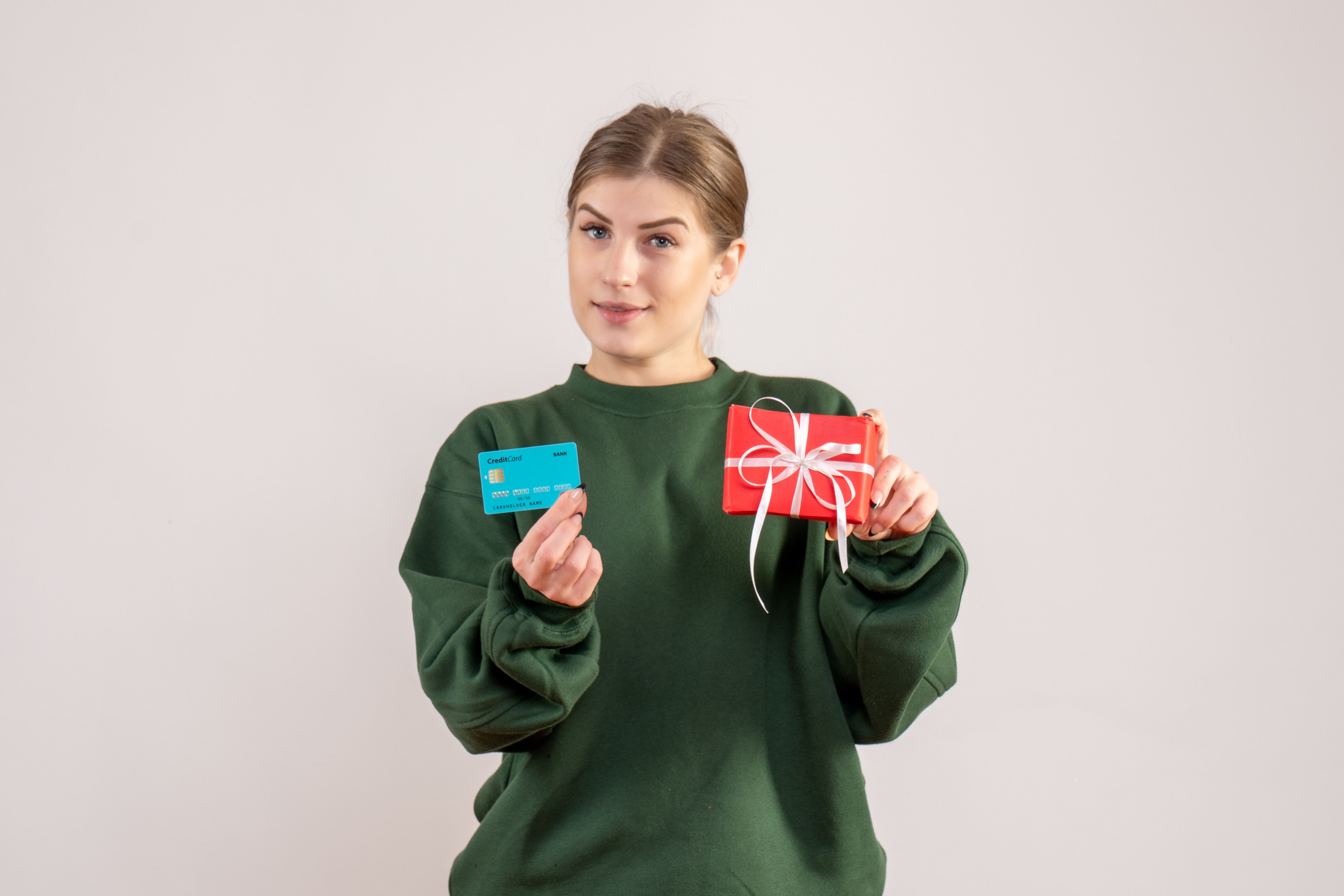 front-view-young-female-with-little-xmas-present-bank-card.jpg
