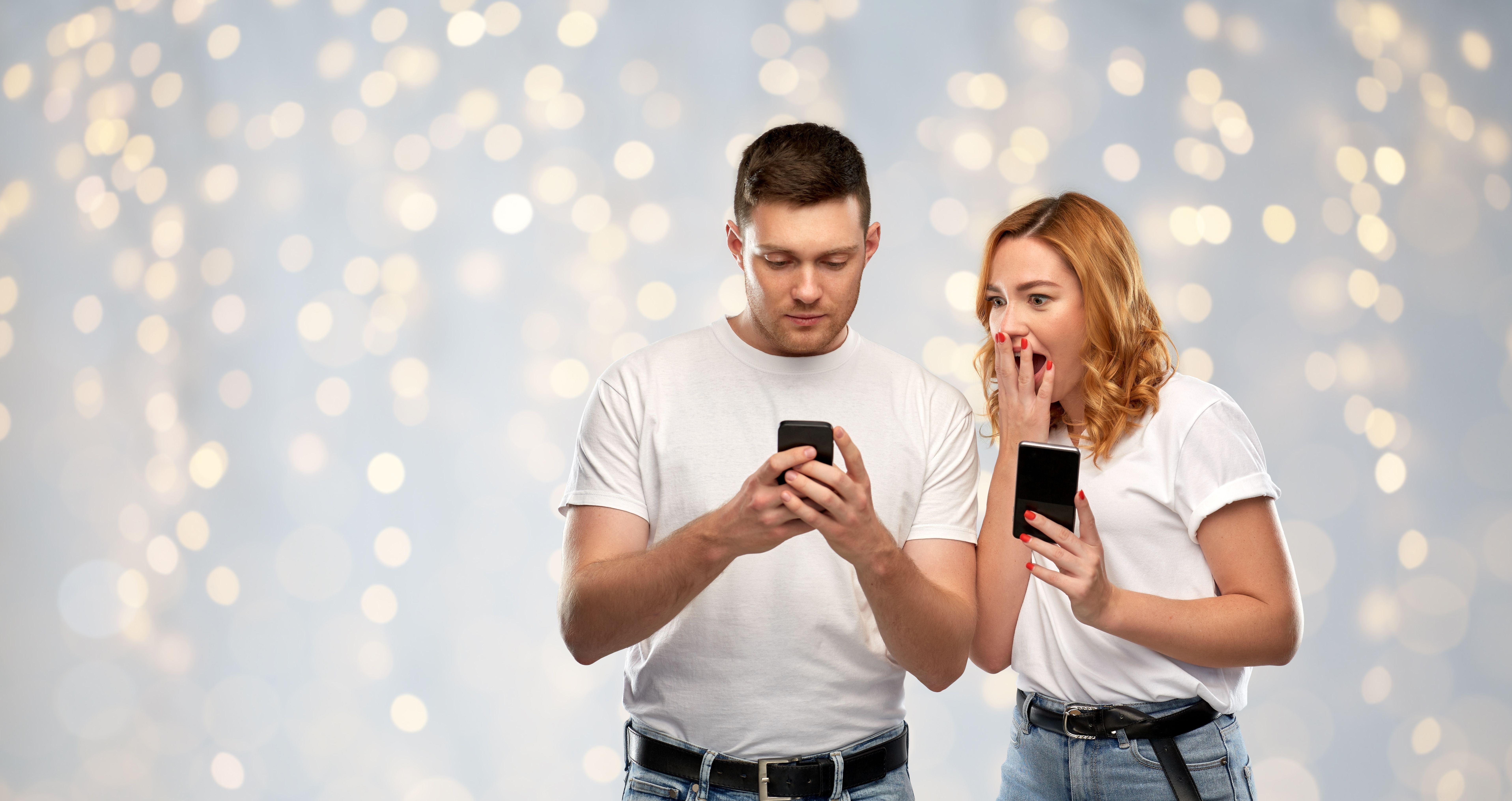 happy-couple-white-tshirts-with-smartphones.jpg