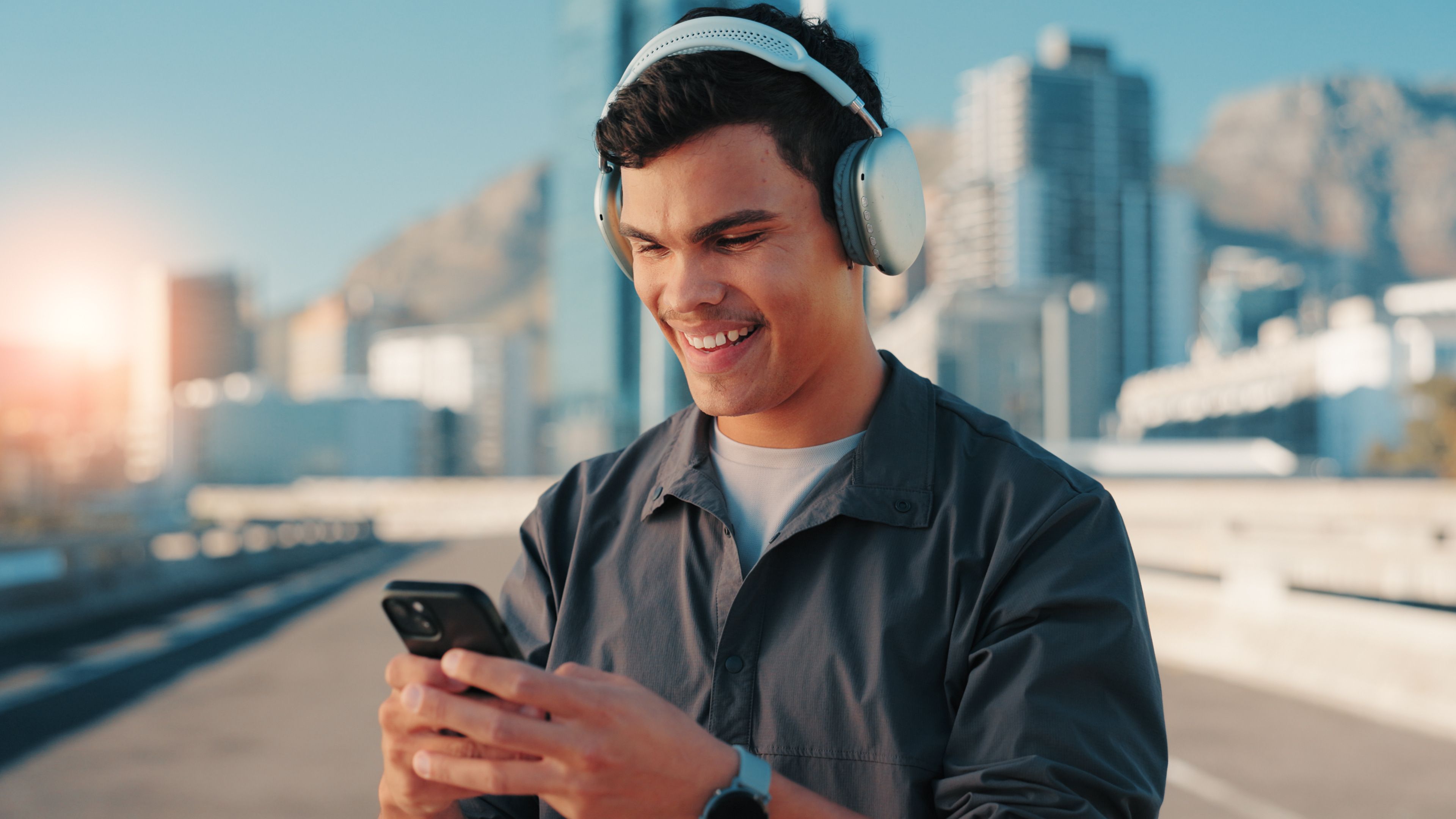happy-man-fitness-listening-with-phone-city-workout-playlist-sound-music-app-active-male-person-user-with-smile-mobile-smartphone-with-headphones-audio-streaming-town.jpg