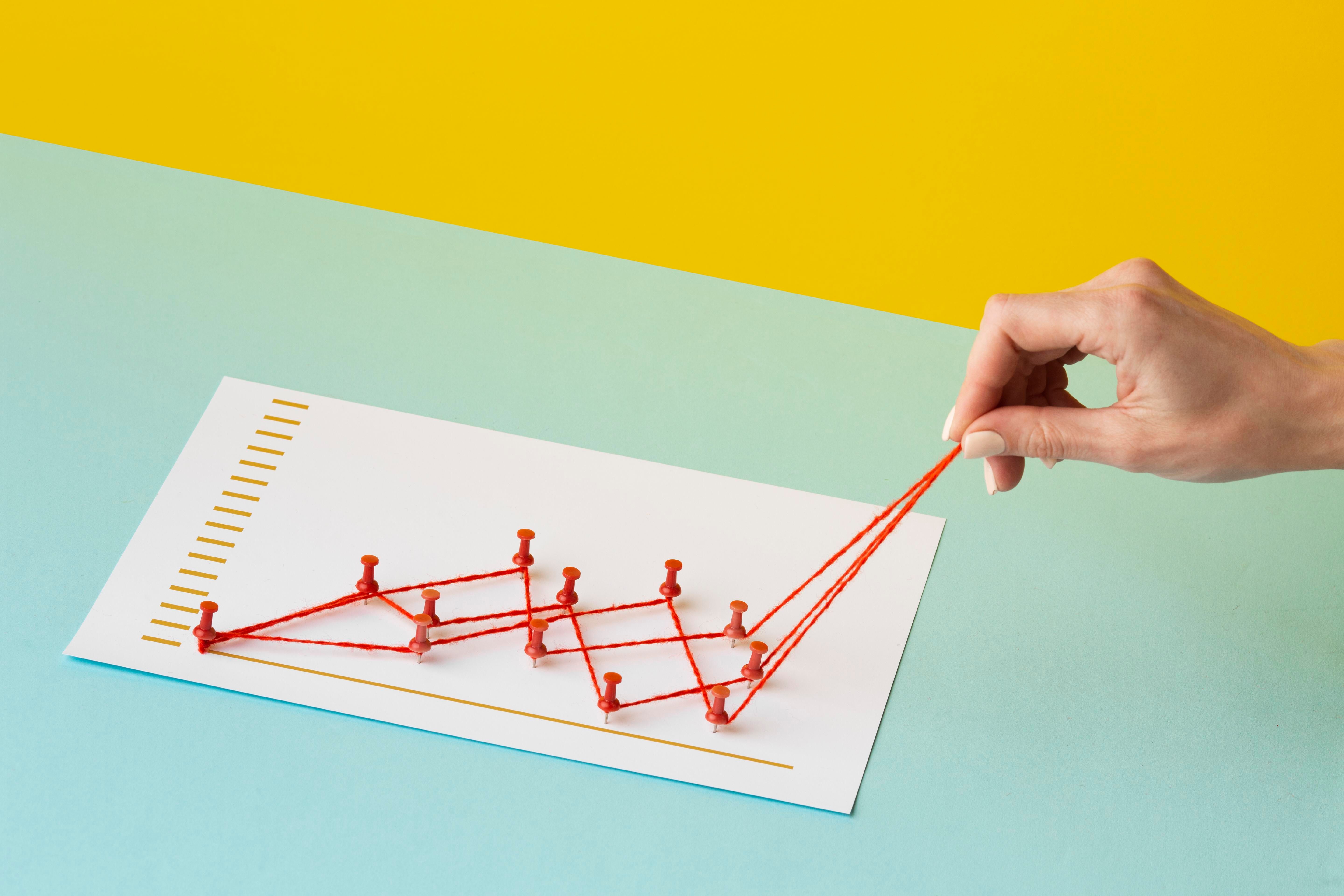 high-angle-chart-statistics-presentation-with-hand.jpg