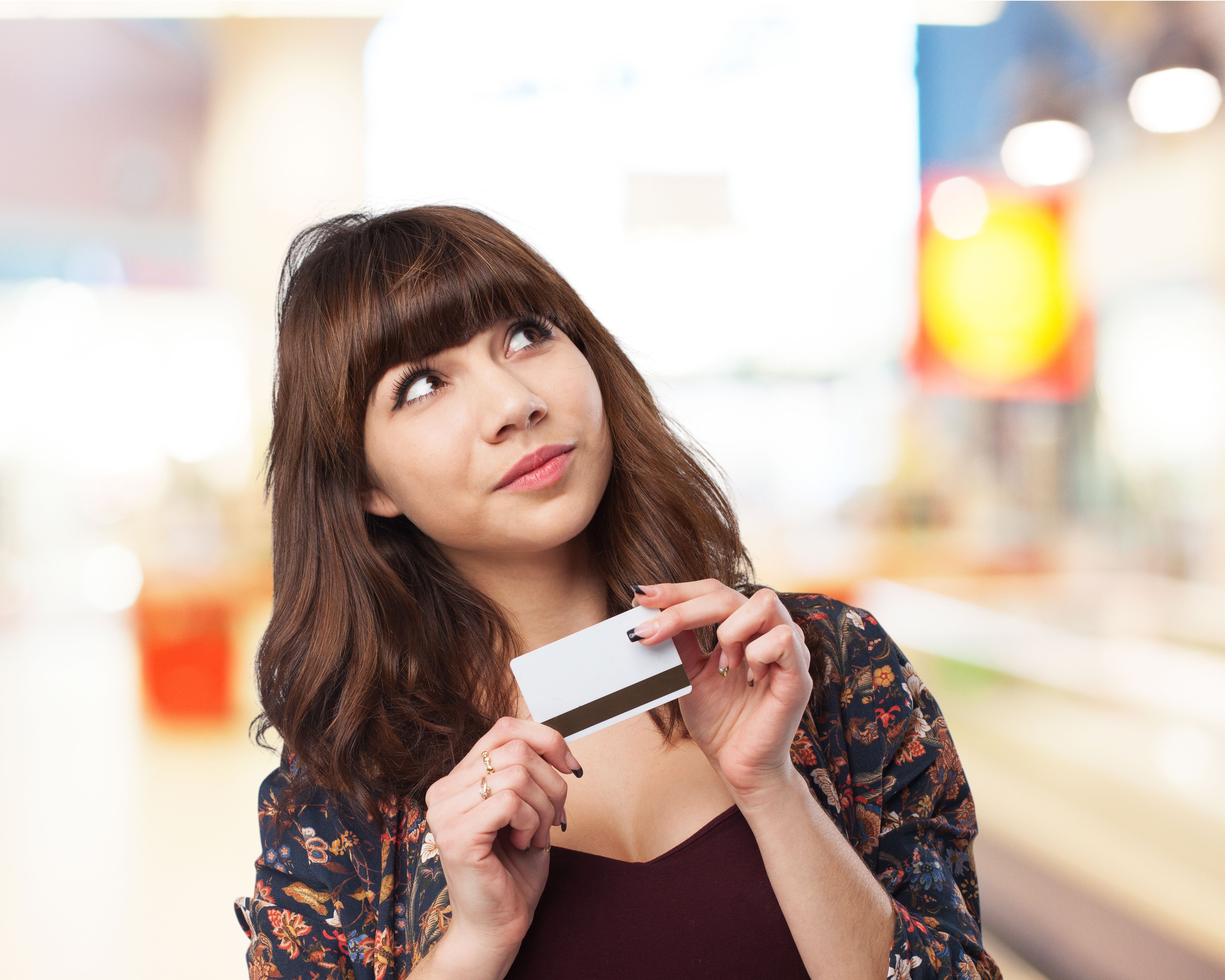 pensive-woman-with-credit-card.jpg
