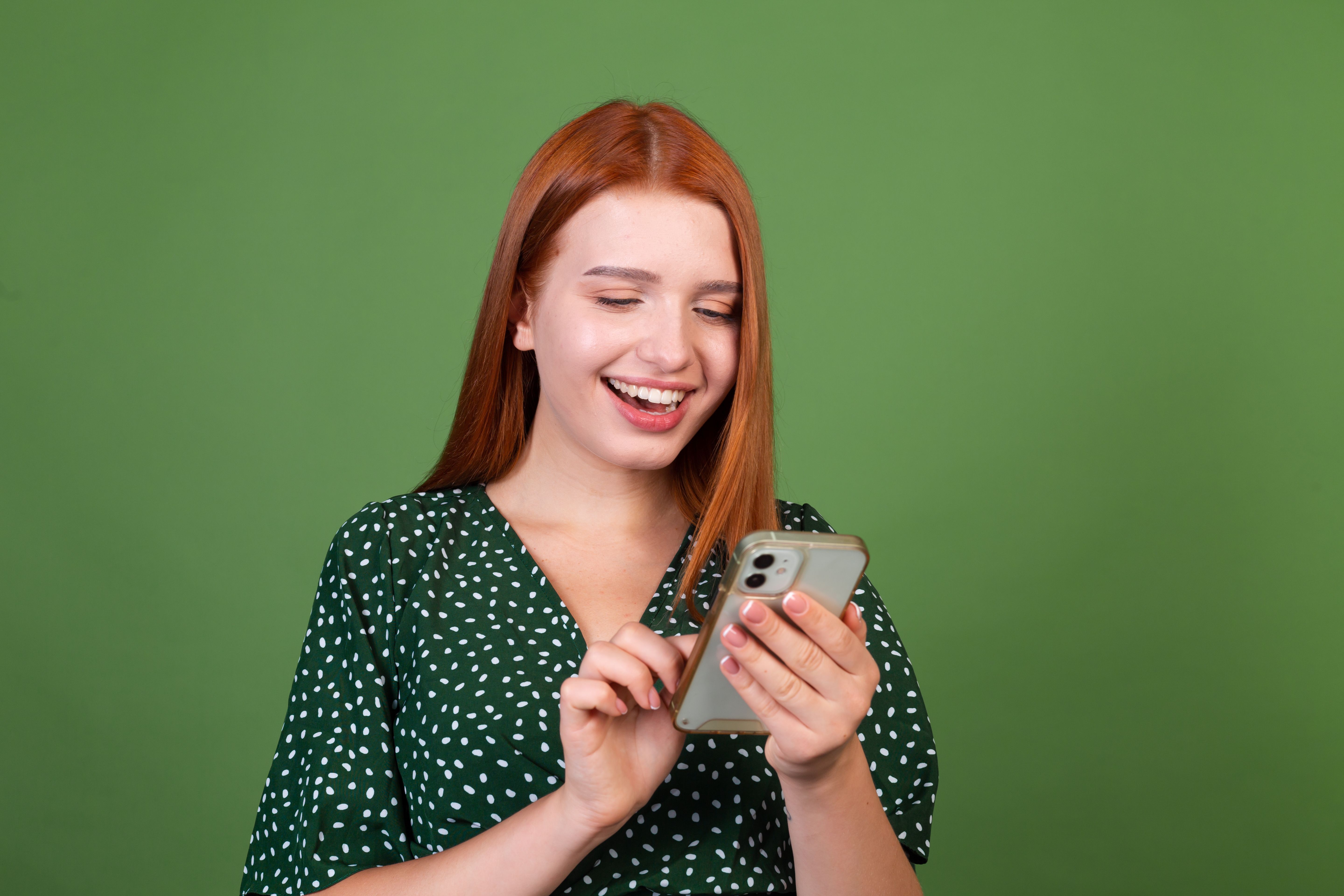 young-red-hair-woman-green-wall-with-mobile-phone-happy-positive-excited.jpg
